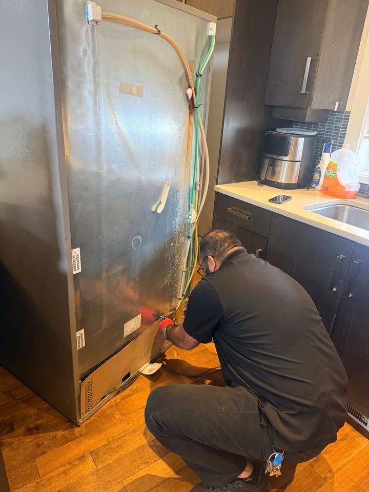 West Coast Wrench technician repairing a refrigerator in a Victoria home